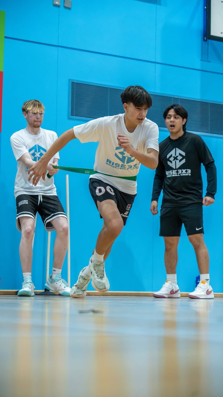 Camper sprinting against a resistance band