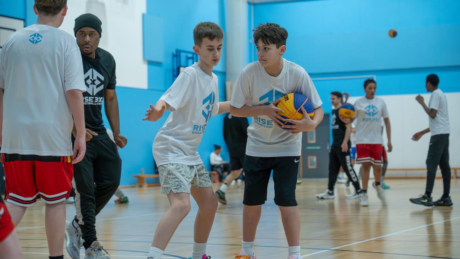 Campers in a ball handling drill with Afiz watching