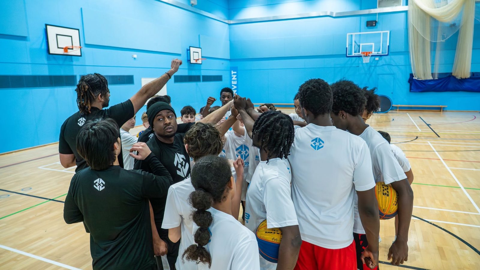 Coaches and campers in a team huddle